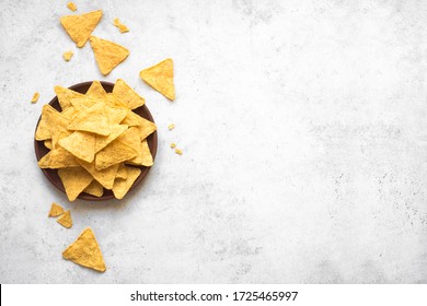 Mexican Corn Chips Nachos On White Background, Top View, Copy Space. Tortilla Or Nacho Chips For Snack.