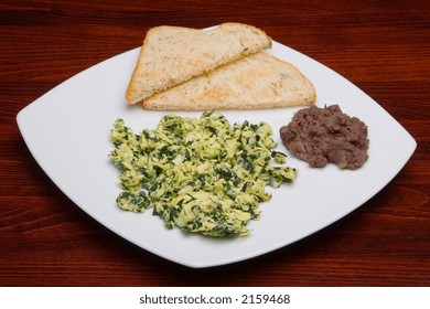 Mexican Cuisine. Scrambled Eggs With Spinach And Beans