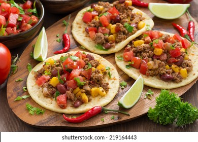 Mexican cuisine - tortillas with chili con carne and tomato salsa, horizontal