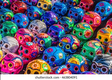 Mexican Culture Celebration: Colorful (colourful) traditional Mexican/hispanic ceramic pottery Day of the Dead (Dia de los Muertos) skulls on display at a market in Mexico. 
 