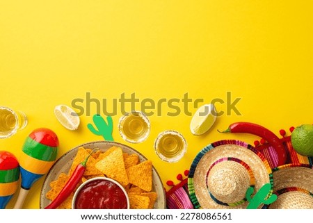 Mexican culture concept. Top view photo of tequila with salt sliced lime nachos chips salsa sauce sombrero multicolor poncho cactus silhouettes maracas on isolated yellow background with empty space