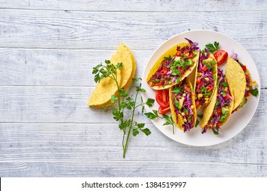 Mexican Dish Taco With Meat, Red Cabbage, Avocado, Cherry Tomatoes, Corn, Chilli, Served On White Plate, Taco Shell On A White Wooden Table, Copy Space, View From Above, Close Up