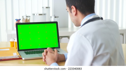 Mexican Doctor Talking To Laptop With Green Screen