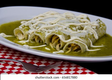 Mexican Enchiladas With Green Sauce Cheese And Sour Cream