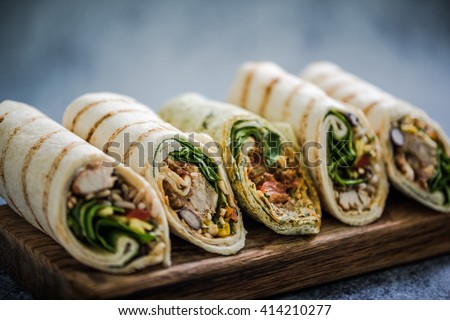 Mexican fajita wraps on serving board, copy space for text or menu