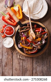 Mexican Fajitas On A Table In A Rustic Style. Vertical Close-up View From Above
