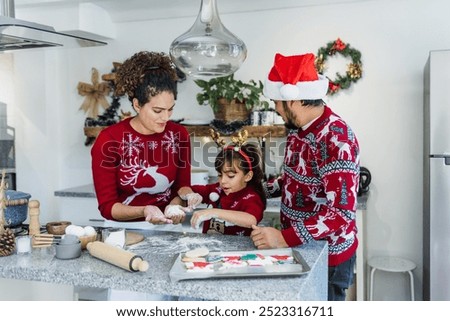 Mexican family mother, father and daughter baking Christmas cookies at home in Mexico Latin America in holidays