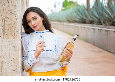 Mexican Folk Dancer Drinking Tequila In A Landscape Of Tequila, Mexico