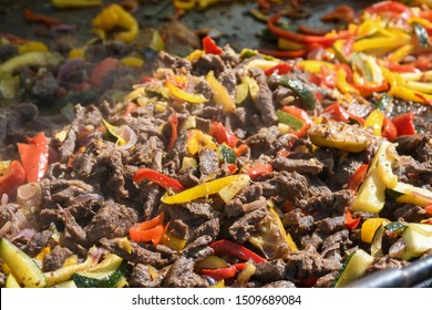 Mexican Food. Beef Fajitas - Traditional Dish Of Mexico. Street Food During Fod Festival. Steaming Vegetables On The Grill. Live Cooking Outdoor Outside Grill. Quesadilla And Tacos Fresh Ingredients