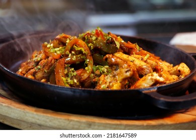 mexican food, chicken fajitas serving on a hot smoking sizzling plate - Shutterstock ID 2181647589