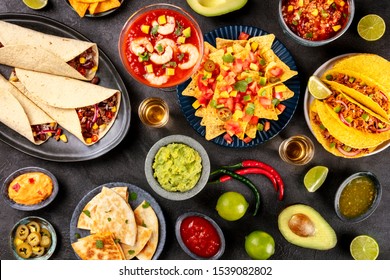 Mexican food, many dishes of the cuisine of Mexico, flat lay, shot from above on a black background. Nachos, tequila, guacamole etc - Shutterstock ID 1539082802