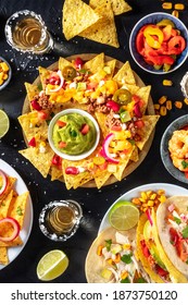 Mexican Food, Various Dishes, Overhead Shot On A Black Background. Nachos, Tacos, Tequila
