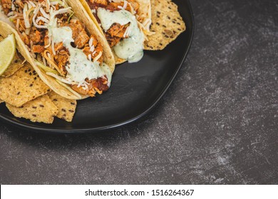 Mexican Fresh Chicken Tacos With Cabbage, Cheese And Cilantro Cream Sauce In A Flour Tortilla With Multigrain Corn Tortilla Chips