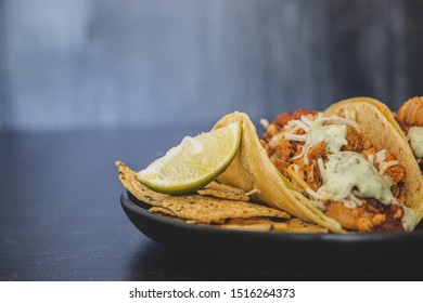 Mexican Fresh Chicken Tacos With Cabbage, Cheese And Cilantro Cream Sauce In A Flour Tortilla With Multigrain Corn Tortilla Chips