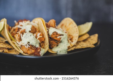 Mexican Fresh Chicken Tacos With Cabbage, Cheese And Cilantro Cream Sauce In A Flour Tortilla With Multigrain Corn Tortilla Chips