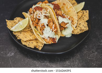 Mexican Fresh Chicken Tacos With Cabbage, Cheese And Cilantro Cream Sauce In A Flour Tortilla With Multigrain Corn Tortilla Chips