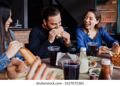 Mexican Friends Eating Tacos Al Pastor In A Taqueria In Mexico City