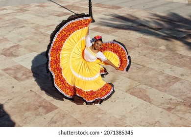 Mexican girl dancer in yellow dress
