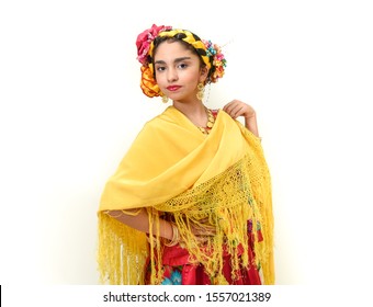 Mexican Girl With A Floral Dress From Oaxaca Mexico, Hidden In A Red Background With Braided Flowers And Gold Necklaces, For Mexican Culture Dance