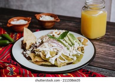 mexican green chilaquiles with chicken and spicy green sauce traditional breakfast in Mexico 