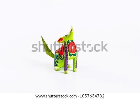 Mexican green and red alebrije from oaxaca isolated on white background.
