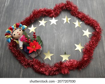 Mexican Handmade Doll, Part Of The Christmas Decoration With Poinsettia Flowers As A Frame For Christmas Messages With Canes And Stars
