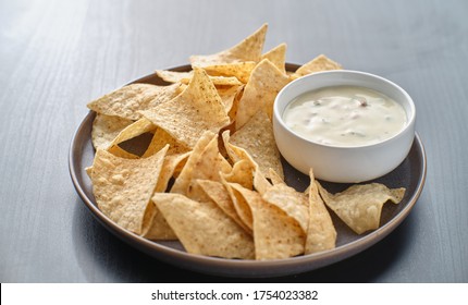 Mexican Hot Queso Blanco Cheese Dip With Corn Tortilla Chips On Plate