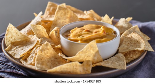 Mexican Hot Queso Cheese Dip With Corn Tortilla Chips On Plate