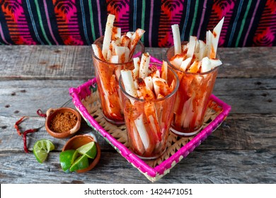 Mexican jicama fruit cutted with green  lime, chili powder and chamoy