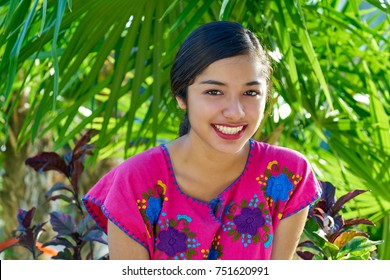 Mexican latin woman with mayan dress smiling in  the jungle