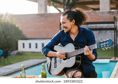 Mexican Man Playing Guitar Outside Home In Mexico City