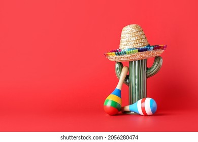 Mexican maracas, cactus and sombrero on color background