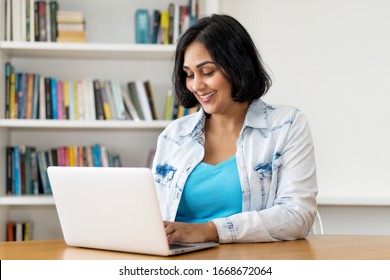 Mexican mature adult woman working at computer at home