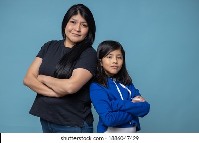 mexican mother and daughter arms crossed, girl power