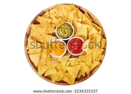 mexican nachos chips with guacamole, salsa and cheese dip on wooden plate isolated on white background, top view