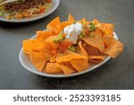 Mexican nachos tortilla chips with jalapeno, guacamole, tomatoes salsa and dip