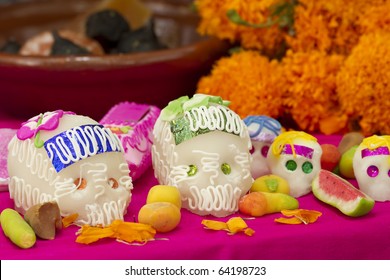 Mexican offering for the dead showing sugar skulls and assorted traditional candy. Holiday Dia de los Muertos.