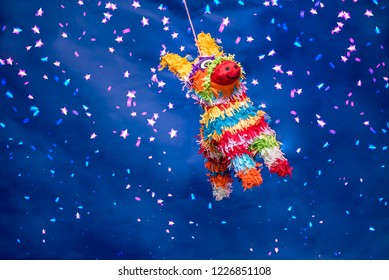 Mexican Piñata Party Hanging On Blue And Green Background With Multi-colored Glitters Celebrating Birthday, Christmas, Party, Party Songs, Figure In The Shape Of Star And Donkey, Family Fun