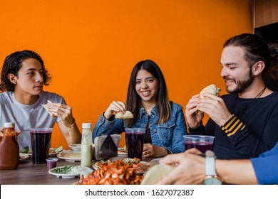 Mexican people eating Tacos al Pastor in a Taqueria in Mexico