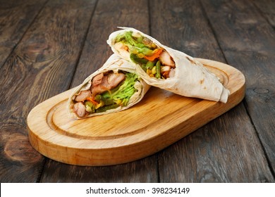 Mexican Restaurant Fast Food - Wrapped Burritos With Chicken And Vegetables Closeup At Wooden Desk On Table