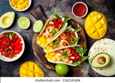 Mexican Shrimp Tacos With Avocado, Tomato, Mango Salsa On Rustic Stone Table. Recipe For Cinco De Mayo Party. Top View, Overhead, Flat Lay. 