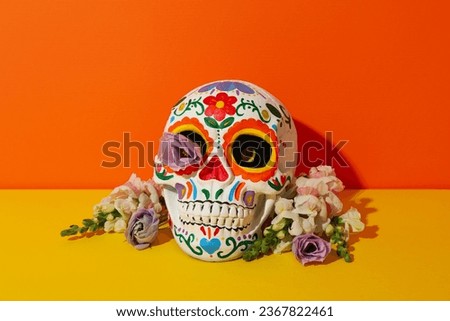 Mexican skull and flowers on orange background