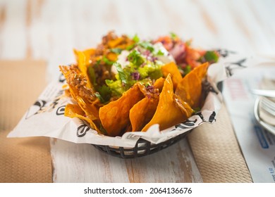 Mexican snack nachos with guacamole and pico de gallo sauce on the table in a mexican restaurant - Powered by Shutterstock