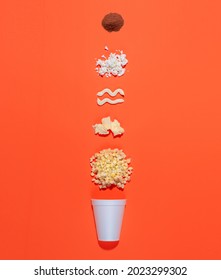 Mexican snack, two trolley, prepared esquite, corn in a cup, with chili powder on orange background, no people