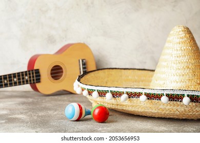 Mexican Sombrero, Guitar And Maracas On Grunge Background