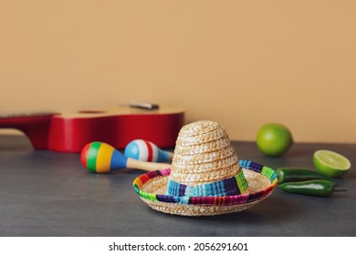 Mexican Sombrero, Guitar And Maracas On Color Background