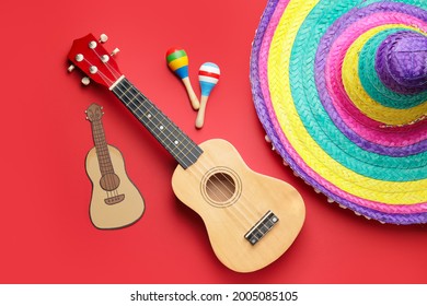 Mexican Sombrero, Maracas And Guitar On Color Background