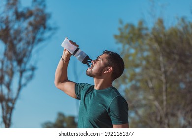 Mexican sports man drinking water