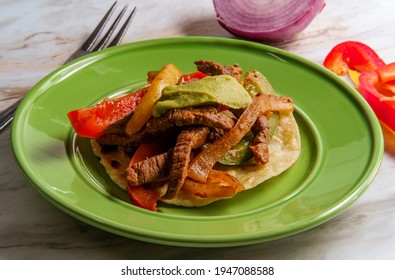 Mexican steak fajitas with fried corn tortillas and guacamole