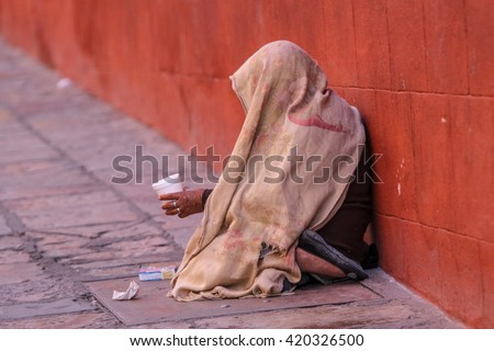 mexican street beggar woman with head covered 